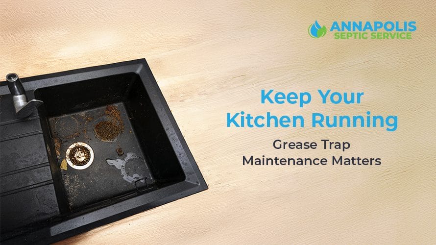 Technician performing commercial grease trap maintenance in a restaurant kitchen